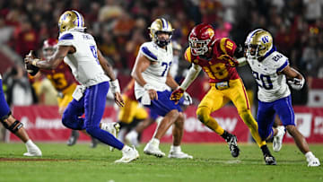 Nov 4, 2023; Los Angeles, California, USA; Washington Huskies quarterback Michael Penix Jr. (9) looks to pass the ball against USC Trojans linebacker Eric Gentry (18) during the fourth quarter at United Airlines Field at Los Angeles Memorial Coliseum. Mandatory Credit: Jonathan Hui-Imagn Images
