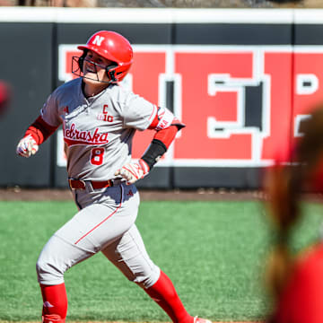 Abbie Squier (8) rounds the bases after hitting a three-run homer. 