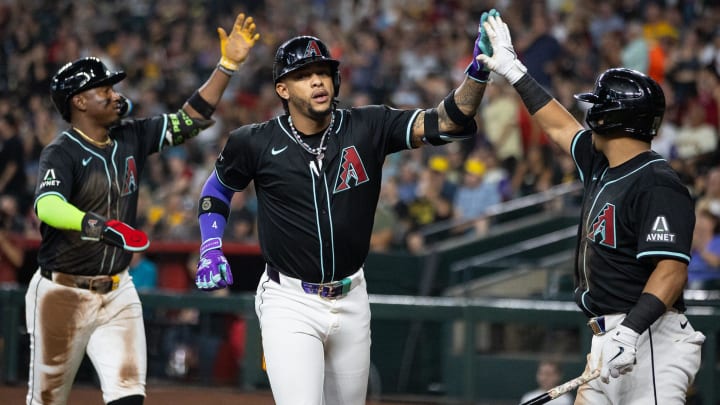 Ketel Marte high fives a teammate following a home run