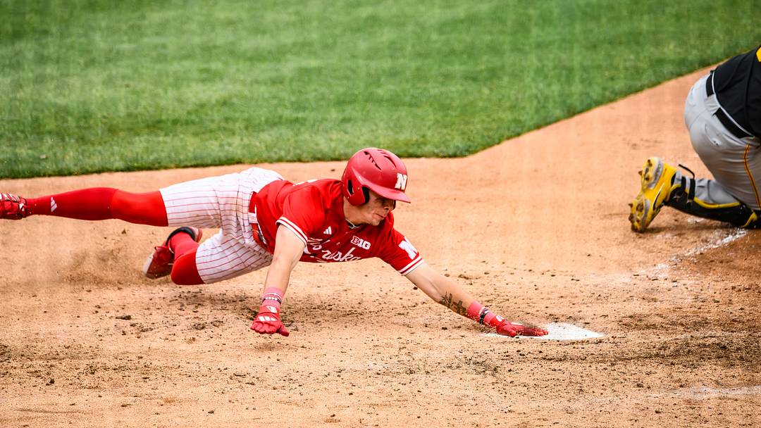 Drew Grego slides home to score a run on a sac fly versus Iowa. Drew Grego slides home to score a run on a sac fly versus Iowa.