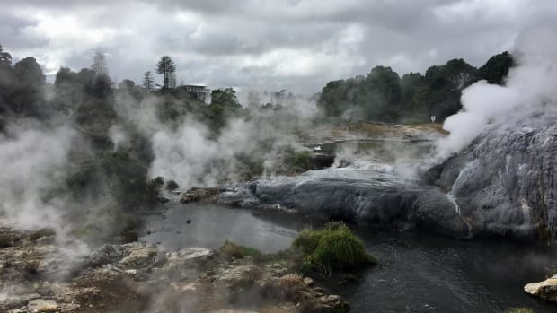 Steam is coming up off water surrounded by rocks.