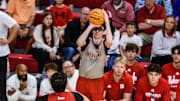 Rutgers transfer, Gavin Griffiths, shoots a three in front of Red team's bench. 