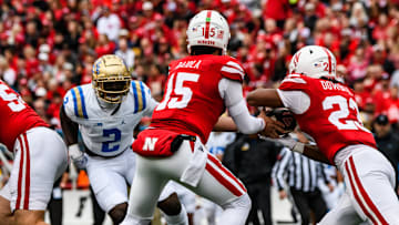 Quarterback Dylan Raiola hands the ball off to running back Dante Dowdell against UCLA.