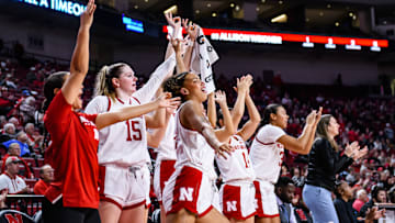 The Husker bench celebrates a three pointer from Logan Nissley. 