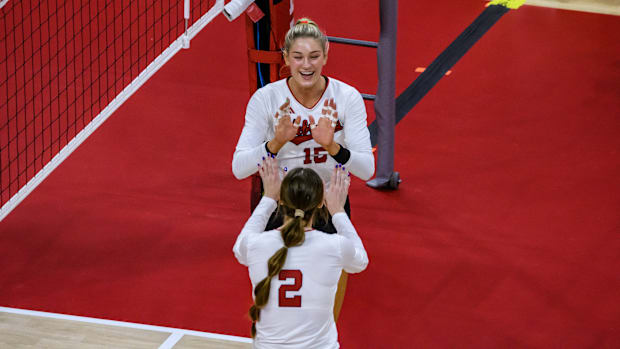 Andi Jackson (15) celebrates her kill with Bergen Reilly (2). 