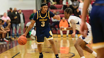 Wayne Memorial's Carlos Medlock Jr. dribbles during the Division 1 boys basketball regional semifinal on Tuesday, March 4, 2025, at Detroit Renaissance High School.