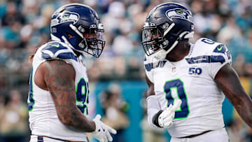 Oct 12, 2025; Jacksonville, Florida, USA; Seattle Seahawks defensive end Leonard Williams (99) and linebacker DeMarcus Lawrence (0) celebrate after a play against the Jacksonville Jaguars at EverBank Stadium.