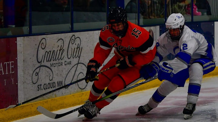 Sartell hockey sophomore Brady Anderson guards Moorhead junior Zak Devig on January 14, 2025 during a game at Scheels Athletic Complex in Sartell. The Sabres lost 3-0.