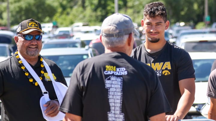 Iowa coach Kirk Ferentz talks with 2025 recruiting target Iose Epenesa (right) and his father, Epenesa Epenesa, practice on Aug. 10, 2024 in Iowa City. (Rob Howe/HN)  