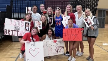 Members of the Nebraska women's basketball team surround Elkhorn North graduate Britt Prince (center, #44) in celebration of her record-breaking night at the NCA All-Star Game. 