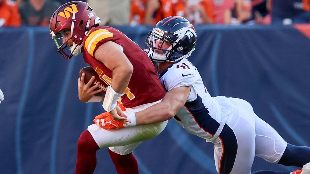 DENVER, CO - SEPTEMBER 17: Washington Commanders quarterback Sam Howell (left) gets sacked by Denver Broncos linebacker Drew Sanders (41). DENVER, CO - SEPTEMBER 17: Washington Commanders quarterback Sam Howell (left) gets sacked by Denver Broncos linebacker Drew Sanders (41).