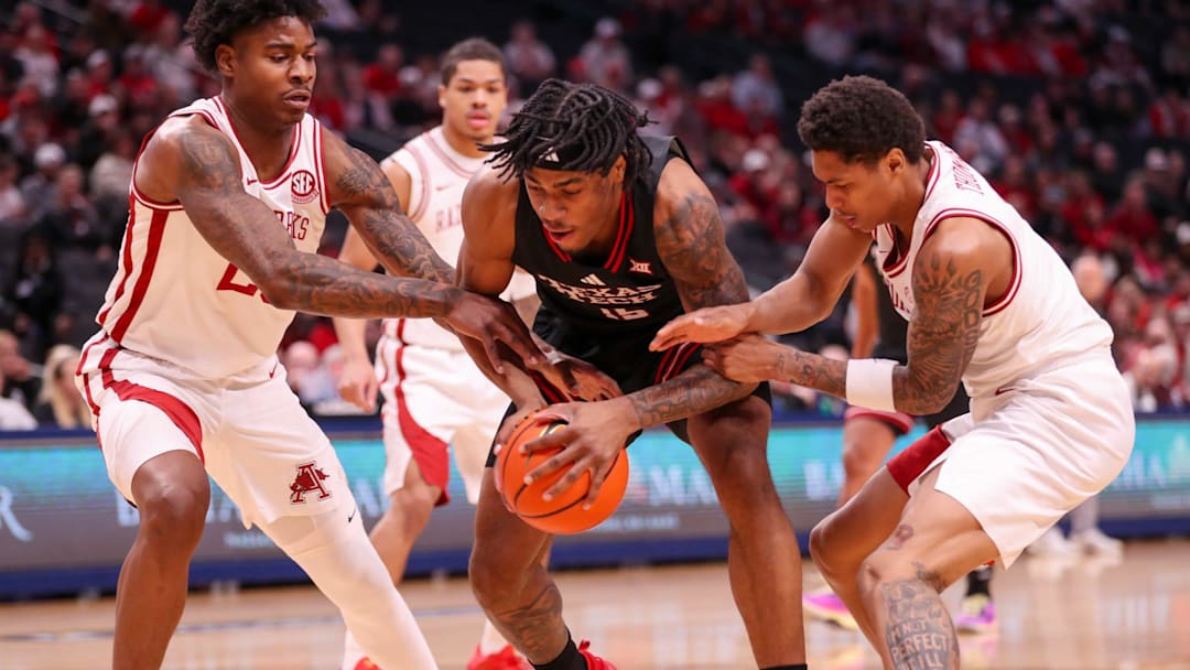 Texas Tech's JT Toppin is crowded by Arkansas defenders Nick Pringle (left) and Meleek Thomas during a non-conference men's basketball game, Saturday, Dec. 13, 2025, at American Airlines Center in Dallas. Texas Tech's JT Toppin is crowded by Arkansas defenders Nick Pringle (left) and Meleek Thomas during a non-conference men's basketball game, Saturday, Dec. 13, 2025, at American Airlines Center in Dallas.