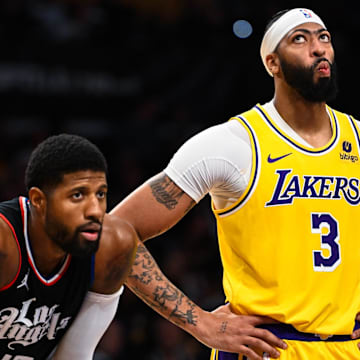 Nov 1, 2023; Los Angeles, California, USA;  Los Angeles Lakers center Anthony Davis (3) looks at the scoreboard with LA Clippers forward Paul George (13) during the second quarter at Crypto.com Arena. Mandatory Credit: Jonathan Hui-USA TODAY Sports