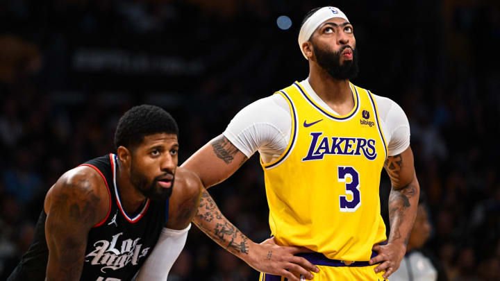 Nov 1, 2023; Los Angeles, California, USA;  Los Angeles Lakers center Anthony Davis (3) looks at the scoreboard with LA Clippers forward Paul George (13) during the second quarter at Crypto.com Arena. Mandatory Credit: Jonathan Hui-USA TODAY Sports