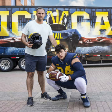 Four-star offensive tackle Avery Gach commits to Michigan football over rivals Ohio State, MSU in the 2025 recruiting class.