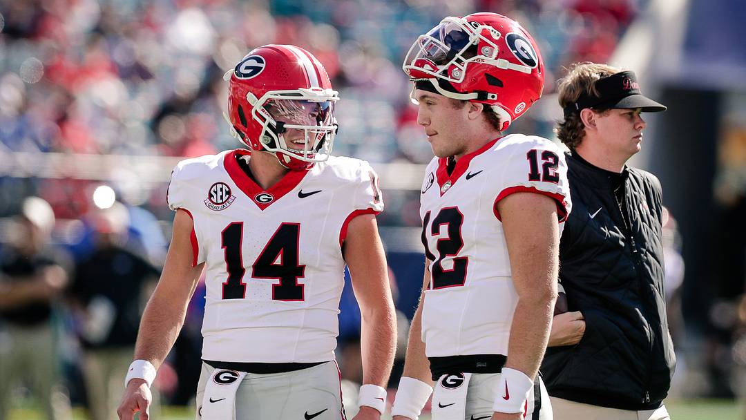 Nov 1, 2025; Jacksonville, Florida, USA; Georgia Bulldogs quarterback Gunner Stockton (14) talks with quarterback Ryan Puglisi (12) before a college football game against the Florida Gators at EverBank Stadium. Mandatory Credit: Travis Register-Imagn Images Nov 1, 2025; Jacksonville, Florida, USA; Georgia Bulldogs quarterback Gunner Stockton (14) talks with quarterback Ryan Puglisi (12) before a college football game against the Florida Gators at EverBank Stadium. Mandatory Credit: Travis Register-Imagn Images