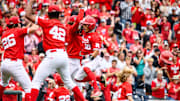Devin Nunez (16) celebrates his home run with the Husker dugout. 
