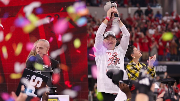 Texas Tech head coach Joey McGuire lifts the trophy as confetti starts to fall after the Red Raiders beat BYU 34-7 in Big 12 Championship football game, Saturday, Nov. 6, 2025, at AT&T Stadium in Arlington.