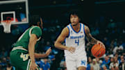 Memphis Tigers’ PJ Haggerty (4) brings the ball up the court against South Florida’s Kobe Knox (4) during a game on Friday, March 7, 2025 at the FedEx Forum in Memphis, Tenn.
