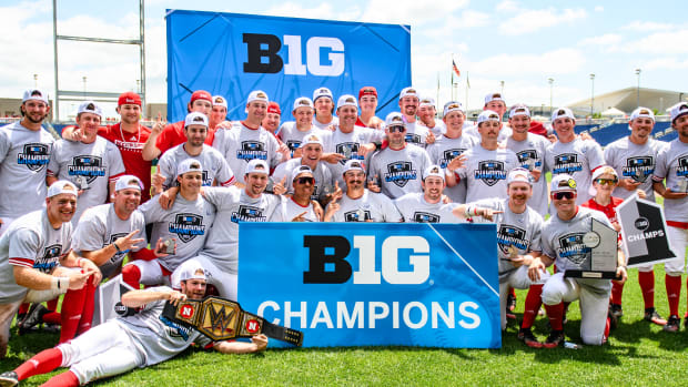 Nebraska baseball poses with the Big Ten Champions banner after winning the 2024 league tournament in Omaha.