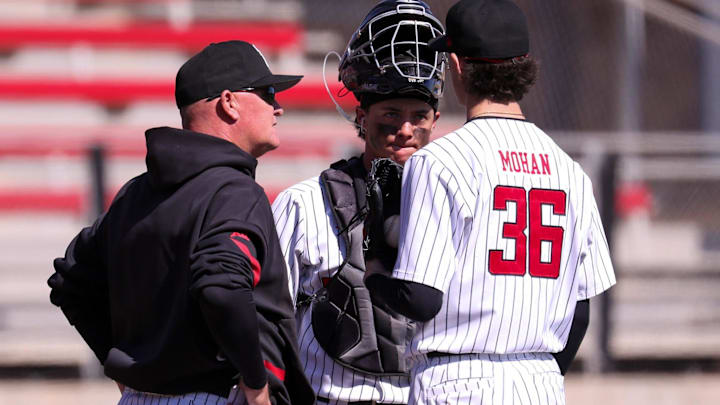 Texas Tech pitching coach Steve Foster (left) meets with Matt Quintanar (center) and Connor Moahn during a non-conference baseball game, Sunday, Feb. 22, 2026, at Rip Griffin Park.