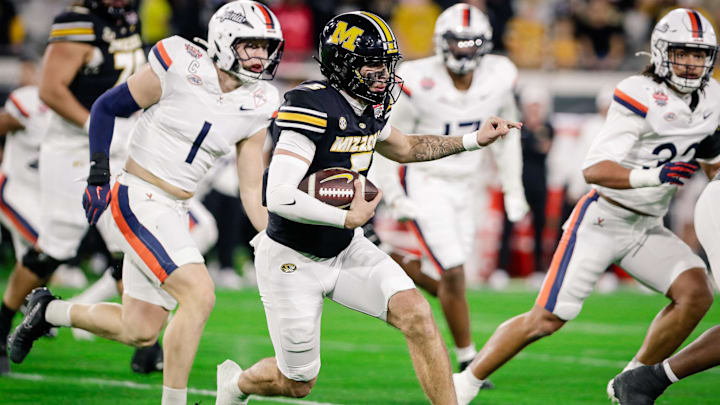Dec 27, 2025; Jacksonville, FL, USA; Missouri Tigers quarterback Matt Zollers (5) runs the ball against the Virginia Cavaliers in the first half at EverBank Stadium. Mandatory Credit: Travis Register-Imagn Images