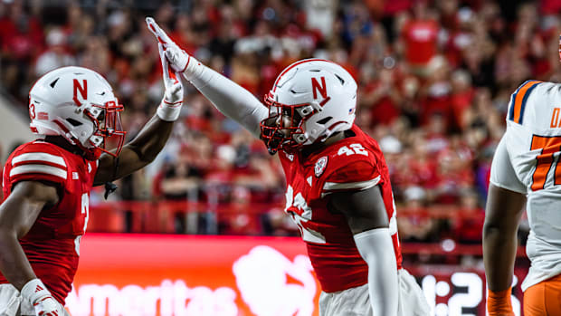 Nebraska Football Marques Buford Jr (left) and Mikai Gbayor high five after a stop on third down. 