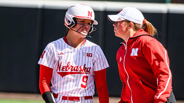 Hannah Camenzind chats with assistant coach Olivia Ferrell after a single. 