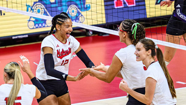 Taylor Landfair (12) celebrates a block with Rebekah Allick. 
