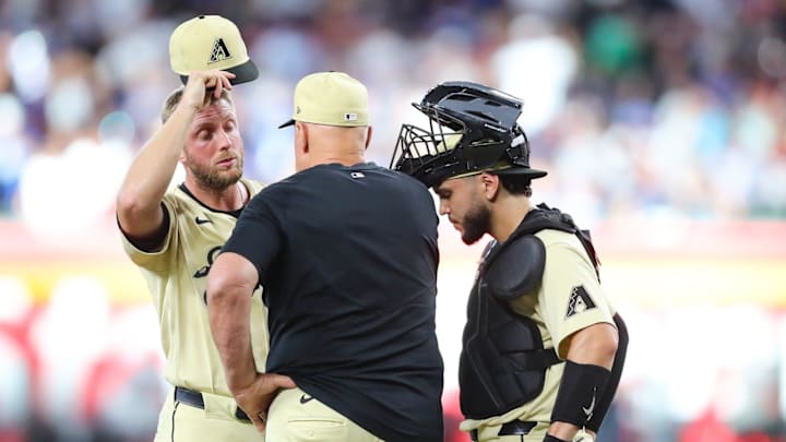 Arizona Diamondbacks pitcher Merrill Kelly (29) is talked to on the mound by pitching coach Brent Strom after giving up back-to-back-to-back home runs at Chase Field on Aug. 31, 2024, in Phoenix.