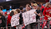 Texas Tech fans hold signs supporting Jacob Rodriguez during the Big 12 Conference championship football game.
