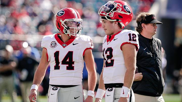 Nov 1, 2025; Jacksonville, Florida, USA; Georgia Bulldogs quarterback Gunner Stockton (14) talks with quarterback Ryan Puglisi (12) before a college football game against the Florida Gators at EverBank Stadium. Mandatory Credit: Travis Register-Imagn Images