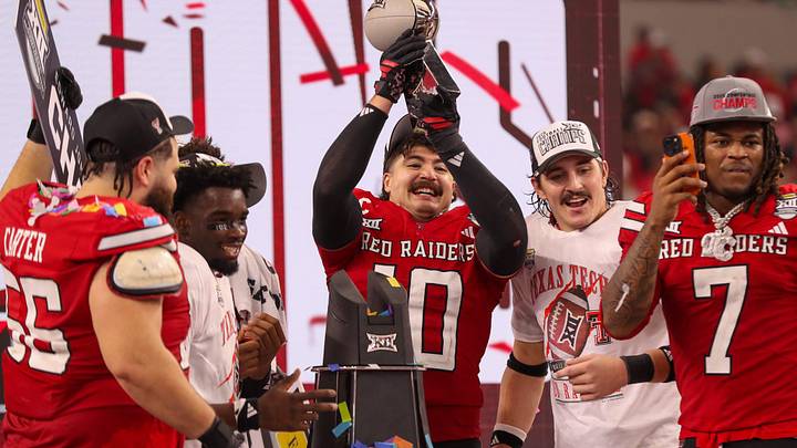 Jacob Rodriguez lifts the trophy after Texas Tech defeated BYU in the Big 12 Conference championship game, Saturday, Nov. 6, 2025, at AT&T Stadium in Arlington.