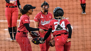 Samantha Bland (left), Jordy Bahl (middle) and Ava Bredwell (24) celebrate Bredwell's diving catch in the infield. 