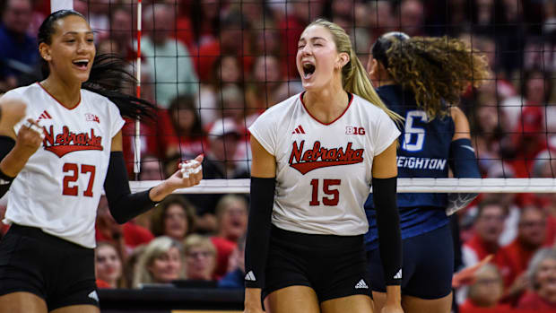 Harper Murray (27) and Andi Jackson (15) celebrate a double block. 