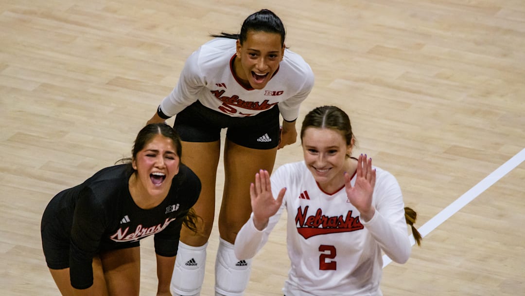 Lexi Rodriguez (left), Harper Murray (middle) and Bergen Reilly celebrate a kill from Rebekah Allick.