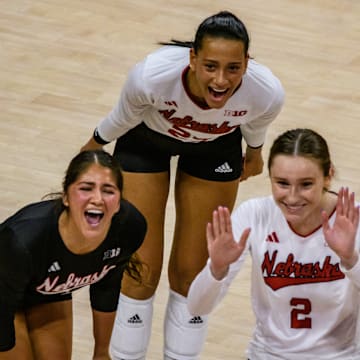 Lexi Rodriguez (left), Harper Murray (middle) and Bergen Reilly celebrate a kill from Rebekah Allick.