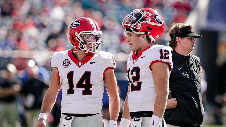 Nov 1, 2025; Jacksonville, Florida, USA; Georgia Bulldogs quarterback Gunner Stockton (14) talks with quarterback Ryan Puglisi (12) before a college football game against the Florida Gators at EverBank Stadium. Mandatory Credit: Travis Register-Imagn Images