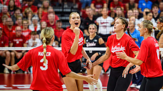 Lauren Stivrins (middle) celebrates a point for the alums in the first set. 