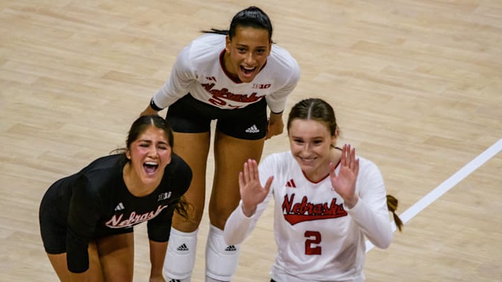 Lexi Rodriguez (left), Harper Murray (middle) and Bergan Reilly celebrate a kill from Rebekah Allick.  