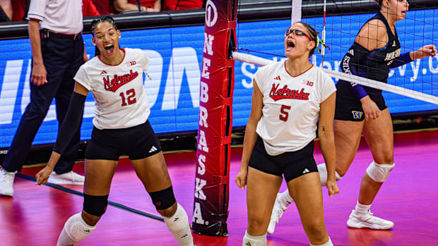 Taylor Landfair (12) and Rebekah Allick (5) celebrate a block. 