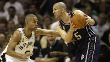 Kidd looks to pass while defended by Parker 