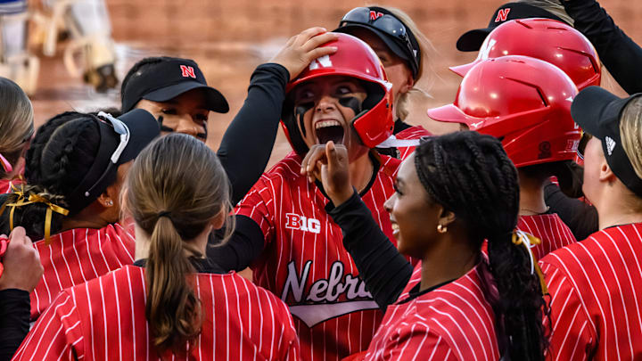 Ava Kuszak celebrates her home run with teammates at home plate. Ava Kuszak celebrates her home run with teammates at home plate.
