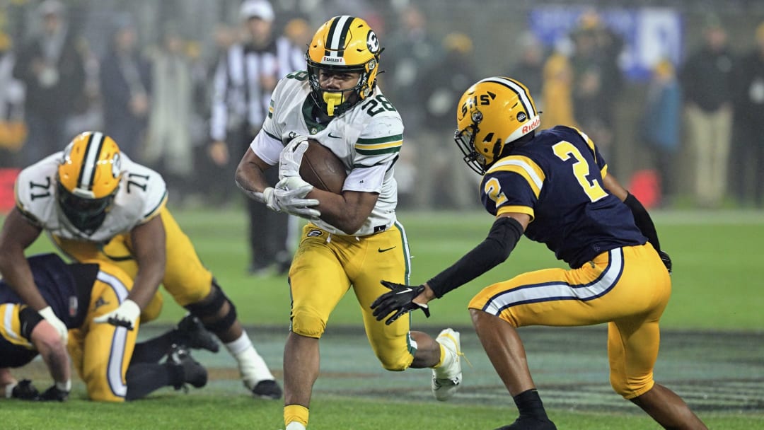 Brandon White of St. Edward runs the football against Springfield int he 2023 OHSAA Division I state championship game at Tom Benson Hall of Fame Stadium in Canton. 