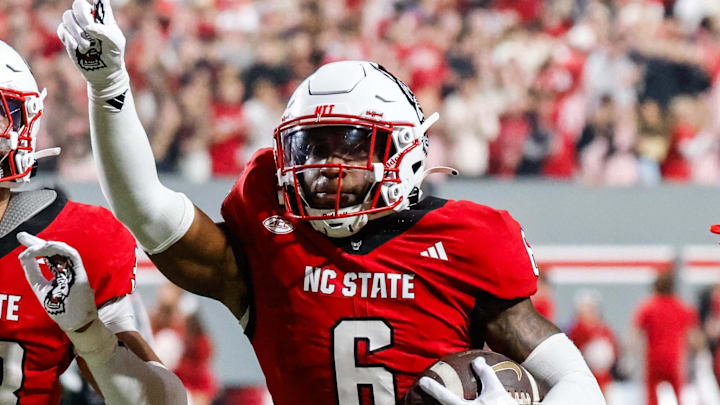 Nov 21, 2025; Raleigh, North Carolina, USA; NC State Wolfpack defensive back Devon Marshall (6) celebrates a down and runs towards the JROTC  to celebrate during the first half of the game against Florida State Seminoles at Carter-Finley Stadium. Mandatory Credit: Jaylynn Nash-Imagn Images