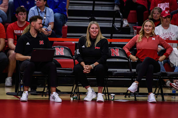 Coach Busboom Kelly smiles after a rally on the court. 
