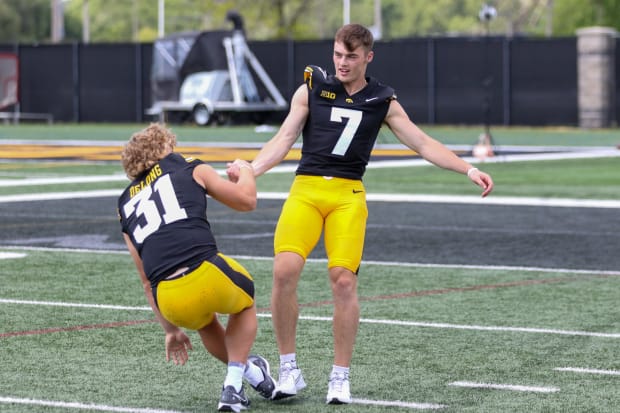 Iowa John Lester )7) helps up teammate Nolan DeLong at the team's annual media day on Aug. 9, 2024 in Iowa City. (Rob Howe/HN