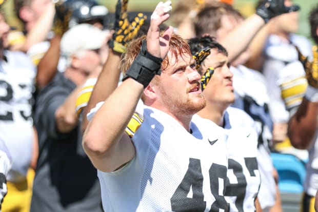 Iowa DL Max Llewellyn waves to the children's hospital at practice on Aug. 10, 2024 in Iowa City. (Rob Howe/HN) 