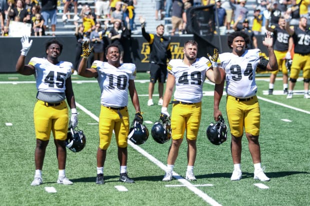 (L-R) Iowa's Deontae Craig, Nick Jackson, Ethan Hurkett and Yahya Black waving to children's hospital at practice on Aug. 10,