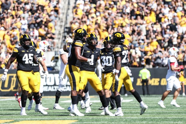 Iowa's Jermari Harris (right) celebrates his interception with teammates. (Photo: Rob Howe/HN) 